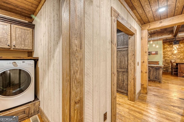 washroom featuring washer / clothes dryer, wooden ceiling, cabinets, and light wood-type flooring