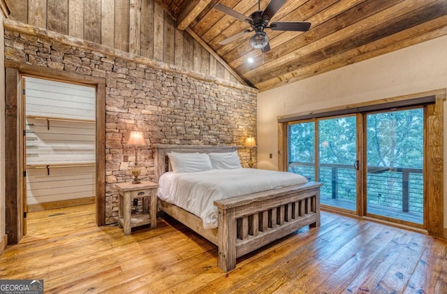 bedroom with wood ceiling, high vaulted ceiling, access to exterior, and light hardwood / wood-style floors