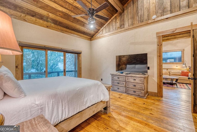 bedroom featuring beamed ceiling, high vaulted ceiling, light hardwood / wood-style flooring, and wooden ceiling