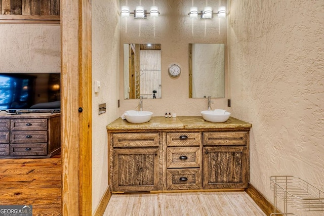 bathroom with wood-type flooring and vanity