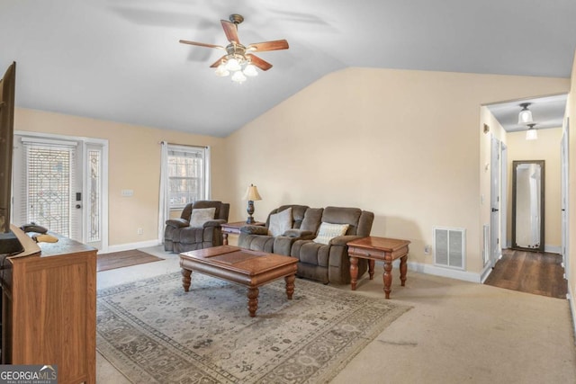 living room with vaulted ceiling, ceiling fan, and carpet