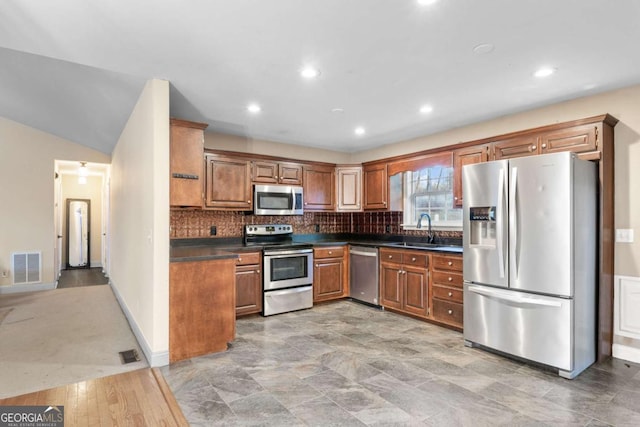 kitchen featuring sink, decorative backsplash, and stainless steel appliances