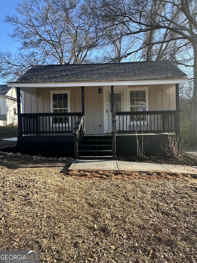 bungalow-style home featuring covered porch and board and batten siding