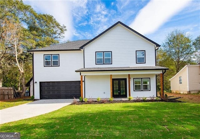 view of front of home featuring french doors, a garage, and a front yard