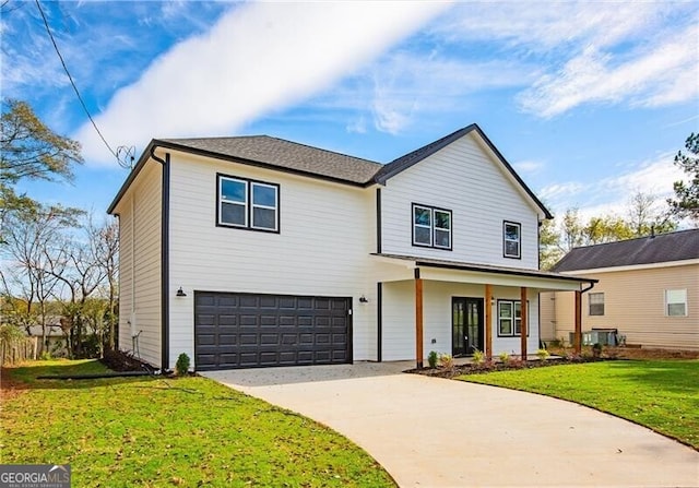 front of property with a garage, a front yard, and central air condition unit