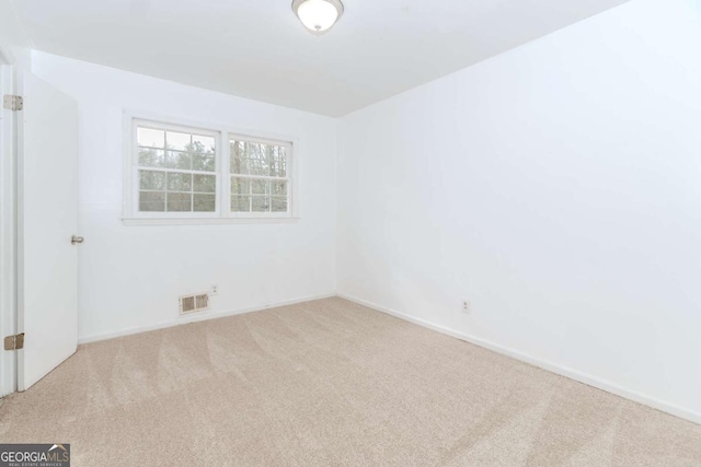 unfurnished room with light carpet