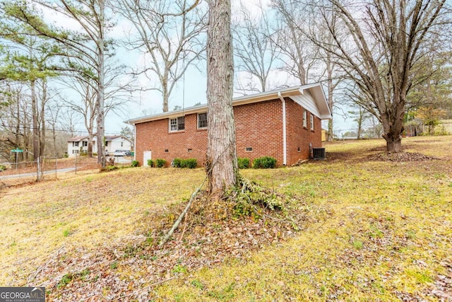 view of home's exterior featuring central AC and a lawn