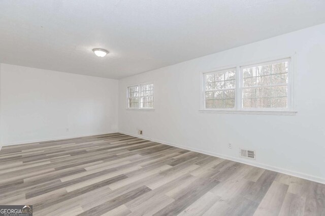 spare room with light hardwood / wood-style floors