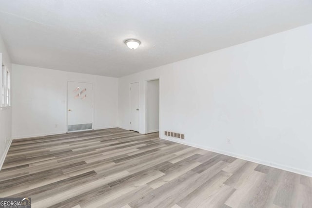 unfurnished room featuring light hardwood / wood-style flooring