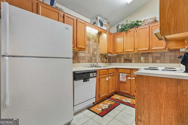 kitchen with sink, vaulted ceiling, a textured ceiling, white appliances, and decorative backsplash