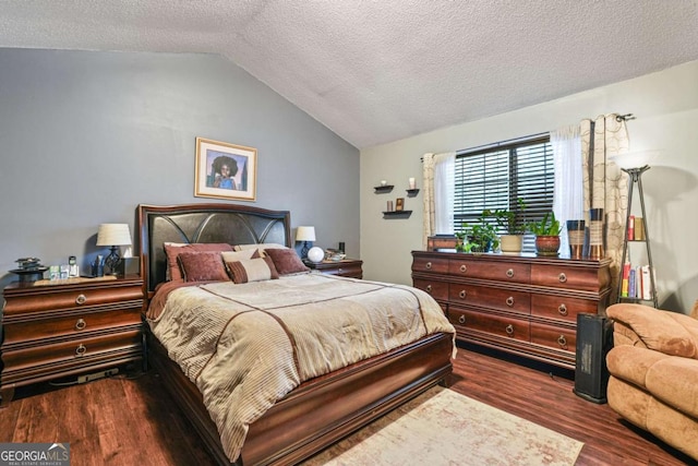 bedroom with lofted ceiling, dark hardwood / wood-style flooring, and a textured ceiling