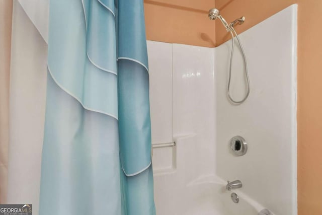 bathroom with shower / bath combo with shower curtain