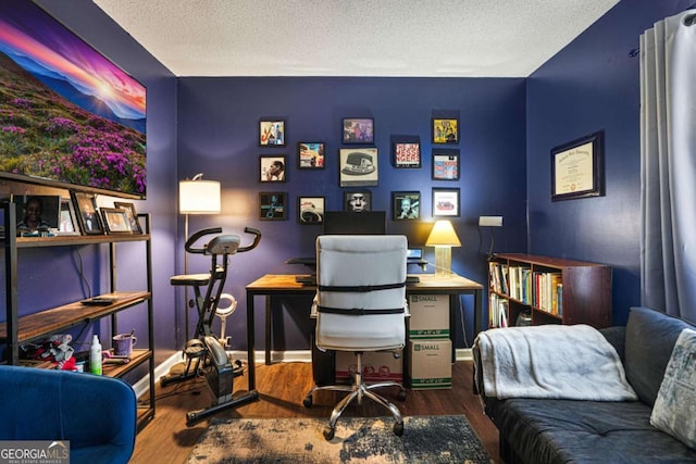 home office featuring hardwood / wood-style flooring and a textured ceiling