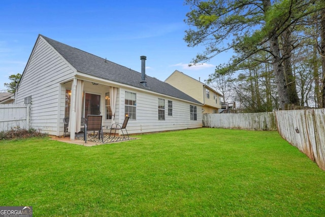 rear view of property with a lawn and a patio area