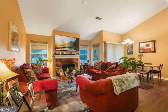 living room with lofted ceiling, a fireplace, a wealth of natural light, and wood-type flooring