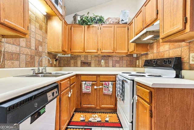 kitchen featuring sink, white appliances, a textured ceiling, and backsplash