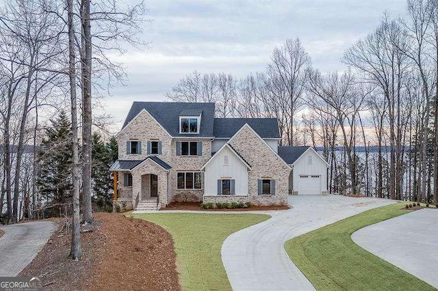 view of front of home featuring a garage and a front lawn