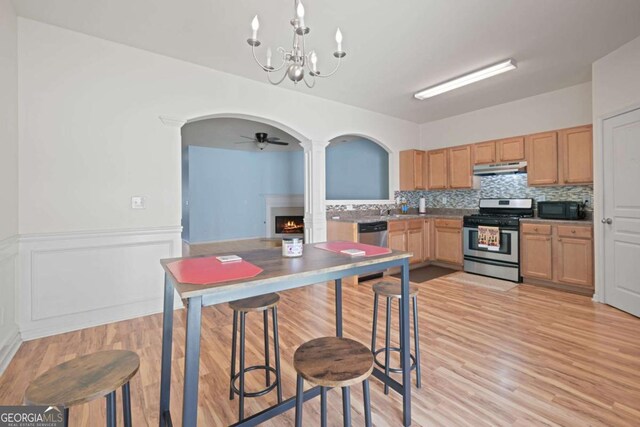 2657 Avanti Way, Decatur, GA 30035 - kitchen with sink, backsplash, hanging light fixtures, stainless steel appliances, and light hardwood / wood-style flooring