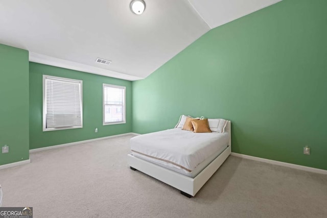 bedroom featuring vaulted ceiling and carpet