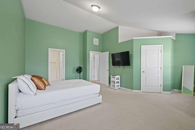 carpeted bedroom with vaulted ceiling