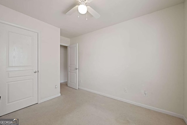 unfurnished bedroom featuring light carpet and ceiling fan