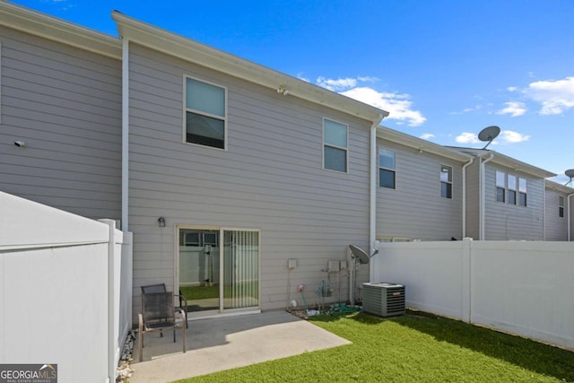 back of house with a patio, a lawn, and central air condition unit