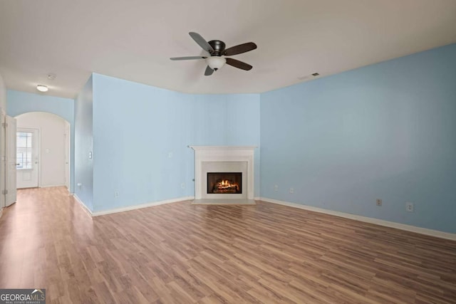 unfurnished living room featuring hardwood / wood-style flooring and ceiling fan