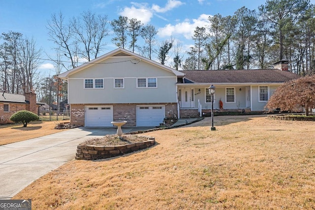 tri-level home featuring a garage and a front yard