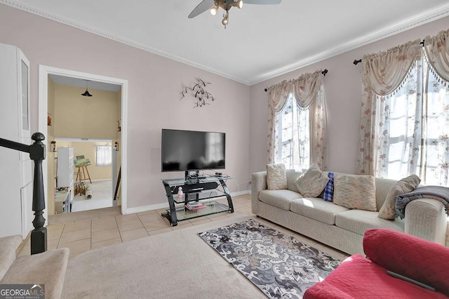 tiled living room with crown molding and ceiling fan