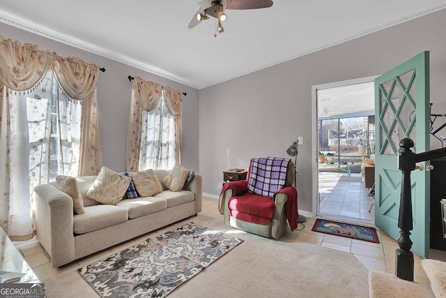 living room featuring ceiling fan, light tile patterned floors, and a wealth of natural light