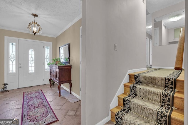 entrance foyer with crown molding, a chandelier, and a textured ceiling