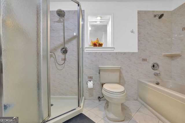 bathroom with toilet, separate shower and tub, tile patterned flooring, and tile walls