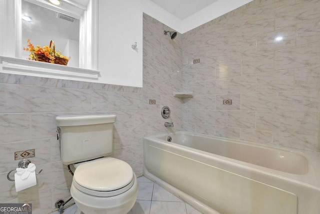 bathroom featuring toilet and tile walls