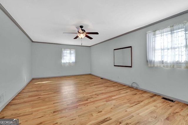 spare room with crown molding, ceiling fan, and light hardwood / wood-style floors