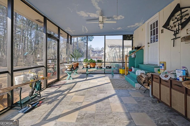 sunroom featuring ceiling fan