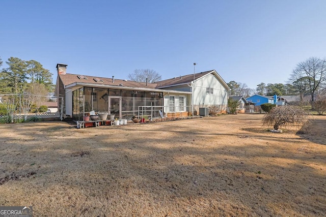 back of property featuring central AC, a yard, and a sunroom