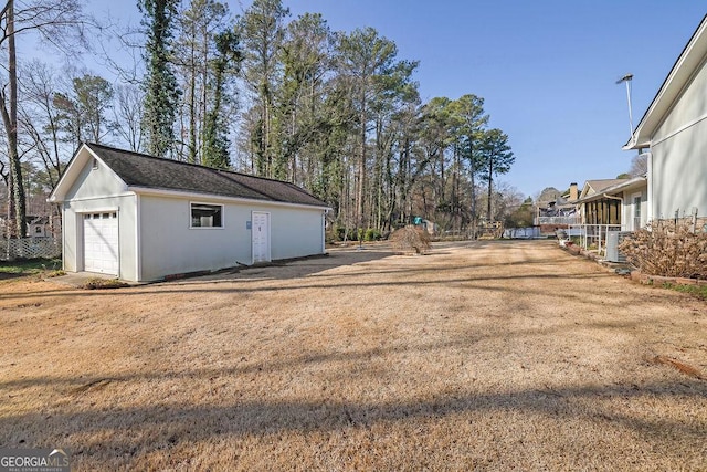 view of yard with an outbuilding and a garage