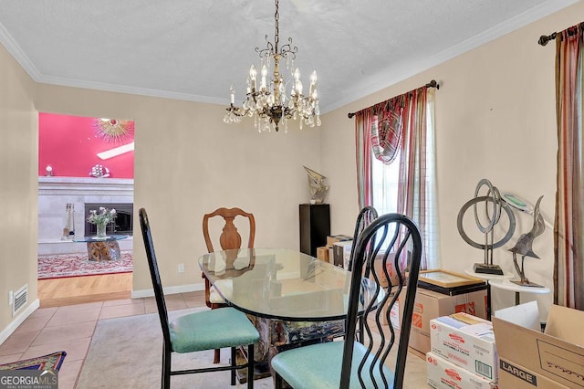 tiled dining room with ornamental molding and a notable chandelier