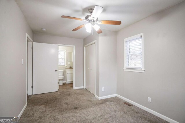 3234 Bluebird Ln, Decatur, GA 30032 - unfurnished bedroom with light carpet, ensuite bath, a closet, and ceiling fan