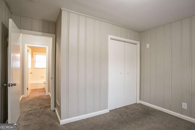 3234 Bluebird Ln, Decatur, GA 30032 - unfurnished bedroom featuring crown molding, a closet, and carpet flooring