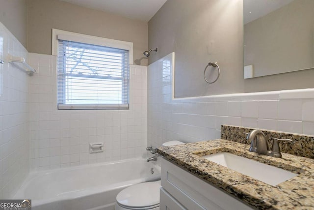 3234 Bluebird Ln, Decatur, GA 30032 - full bathroom with tile walls, vanity, tiled shower / bath, and toilet