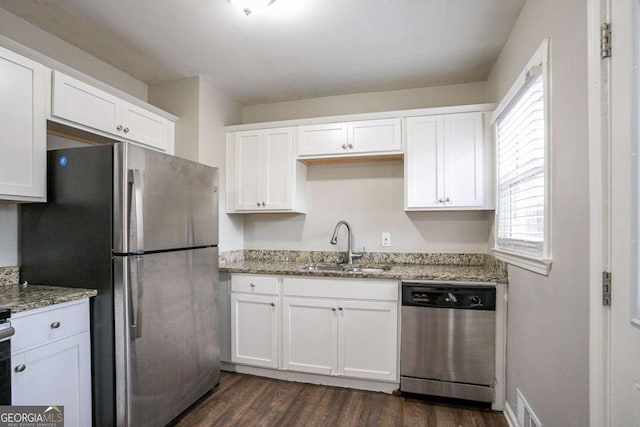 3234 Bluebird Ln, Decatur, GA 30032 - kitchen featuring sink, appliances with stainless steel finishes, white cabinetry, light stone countertops, and dark hardwood / wood-style flooring