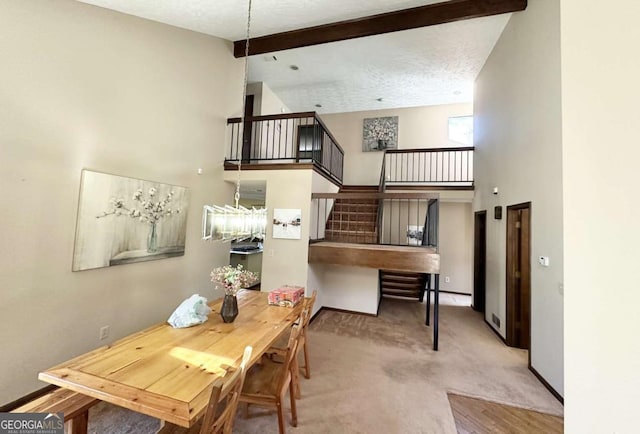 carpeted dining space featuring beamed ceiling, a textured ceiling, and high vaulted ceiling