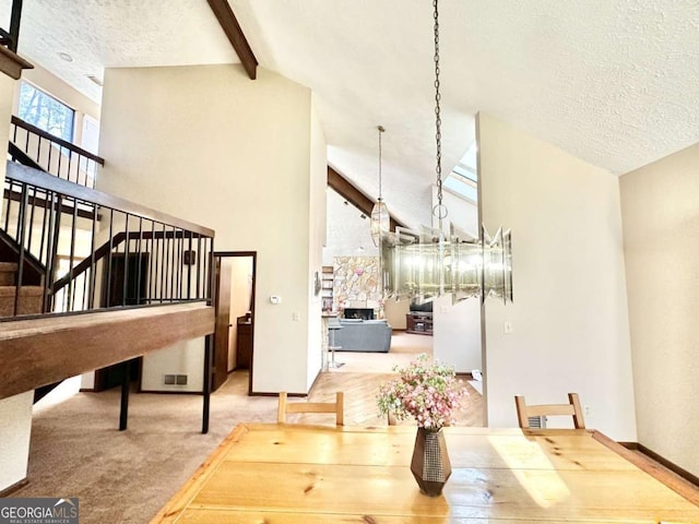 carpeted dining area with beamed ceiling, high vaulted ceiling, and a textured ceiling