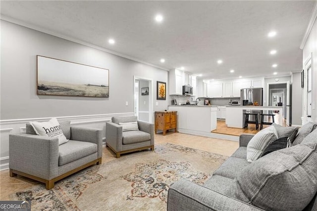 living room with crown molding and sink