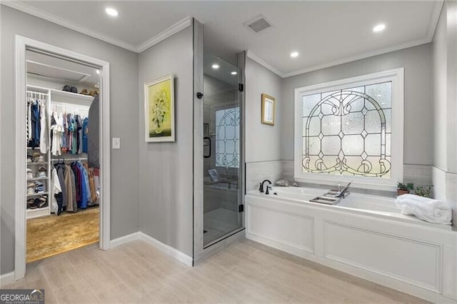 bathroom featuring hardwood / wood-style flooring, ornamental molding, and shower with separate bathtub