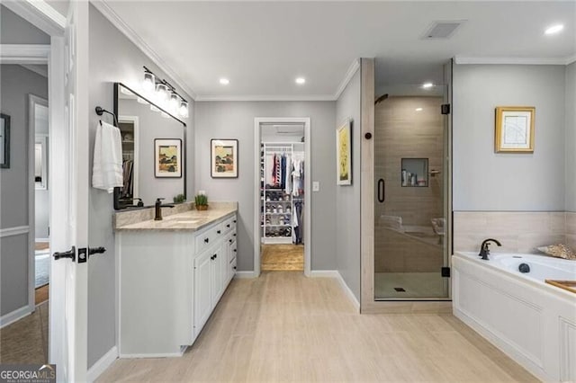 bathroom with crown molding, vanity, independent shower and bath, and hardwood / wood-style floors