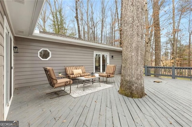 wooden deck featuring outdoor lounge area