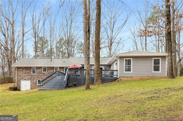 back of house with a wooden deck and a yard