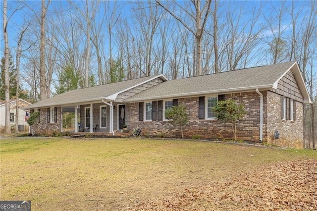 ranch-style home with a front yard and covered porch